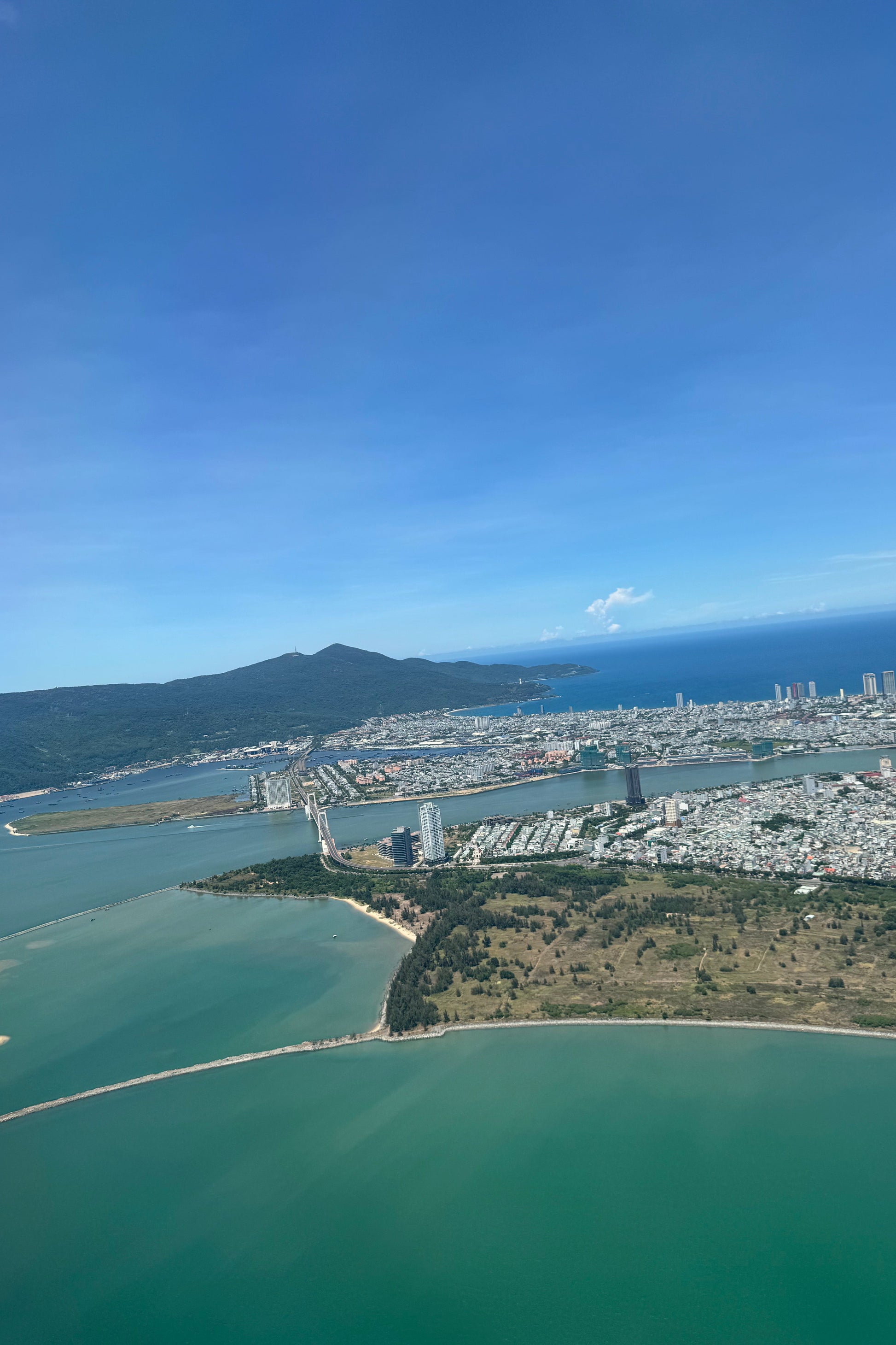 Cityscape with a large body of water and clear blue sky