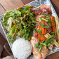Farm to table dish with fish, vegetables, and rice on a wooden table
